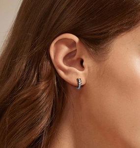 Close-up of black U-shaped S925 silver hoop earring with five inlaid round diamonds