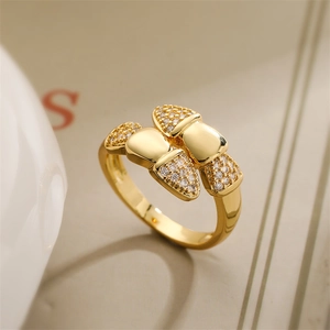 Macro shot of gold-plated bow ring featuring sparkling zircon stones and a polished finish