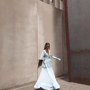 Light blue bohemian long-sleeved dress with ruffled hem and V-neckline styling