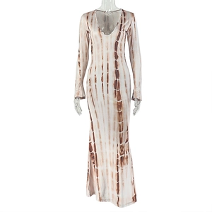 Close-up of brown and white tie-dye fabric on a long sleeve V-neck maxi dress