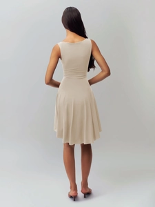 Back view of a slim-fit beige sleeveless dress with backless cut and stretchy fabric