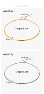 Flat lay detail of gold and silver snake bone necklaces showing length and thickness