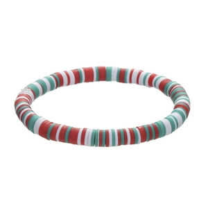 Christmas beaded bracelet with red, green, and white clay beads featuring festive charms