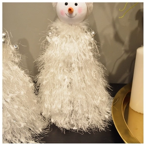 Detail of plush snowman Christmas tree with soft fur texture and silver ball ornaments