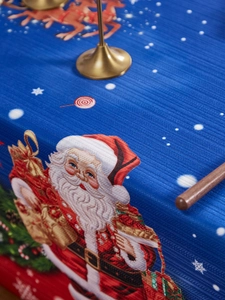 Detail of Christmas tablecloth showing Santa Claus print on textured navy fabric