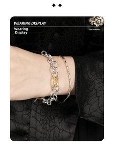 Close-up of dual-tone S925 silver OT buckle bracelets with textured chain link details