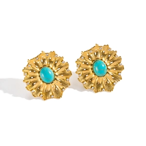 Detailed macro shot of vintage flower earrings with turquoise stones and zircons