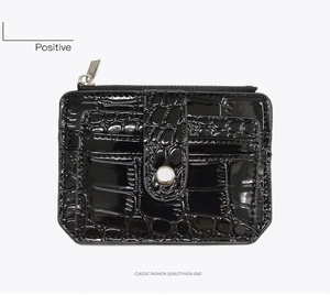 Front view of black crocodile texture card holder with silver snap and top zipper closure