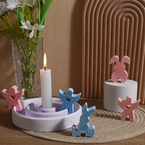 Figuritas de conejo y ángel de yeso con candelabro escalonado en colores pastel