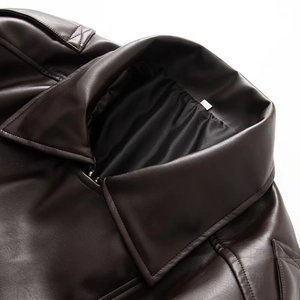 Close-up of deep brown leather jacket showing collar, stitching, and metal zipper details