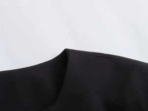Detailed close-up of precise stitching and premium black fabric texture on casual jacket