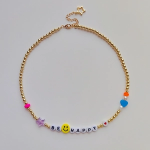 Bohemian gold beaded necklace with colorful star heart charms and Be Happy letter beads