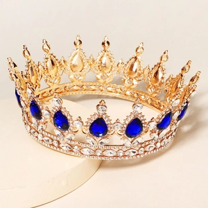 Baroque gold bridal crown featuring teardrop blue gemstones and sparkling crystals