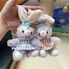 Close-up of cute purple plush bunny keychains with pink and blue checkered dresses