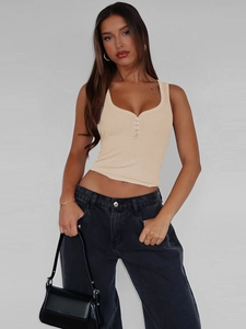 Close-up of apricot ribbed knit crop top featuring classic button-up henley neckline