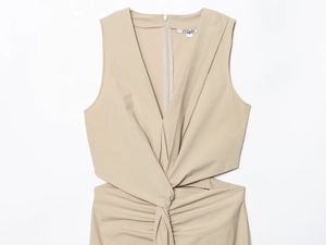Detailed view of the beige sleeveless dress featuring waist knot and cutout design