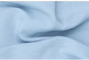 Close-up of light blue slouchy beanie fabric with breathable knit texture and soft folds