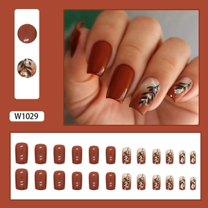 Caramel leaf press-on nails with gold foil accents in mid-length square shape