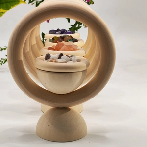 Detailed view of natural wooden rings and bowls filled with colorful crystal stones
