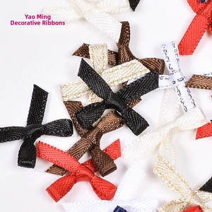 Detailed close-up of colorful handmade polyester ribbon bows with metallic glitter edges