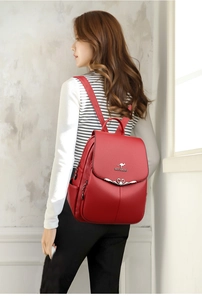 Red soft leather backpack for women with kangaroo logo and heart buckle detail