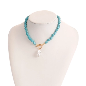 Detail of turquoise bead necklace with baroque pearl pendant and gold OT toggle clasp