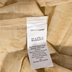 Close-up of jacquard fabric texture and 100% polyester care label on women's set