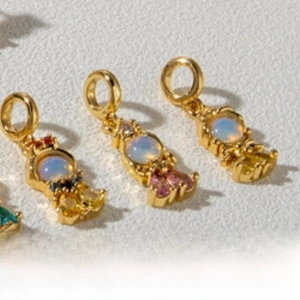 Detailed macro view of mermaid tail pendants with colorful zircons for DIY jewelry