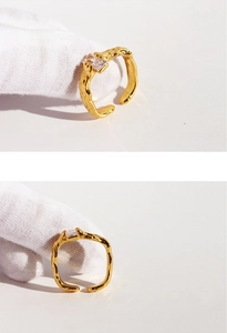 Close-up of golden irregular lava texture ring with square zircon stone inlay