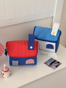 Detailed view of creative house-shaped toiletry bags with vibrant patterns and top handle