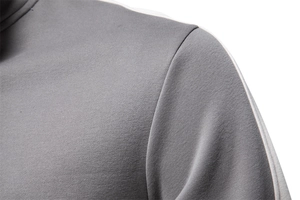 Close-up of gray athletic sweatshirt fabric with white shoulder stripe detail