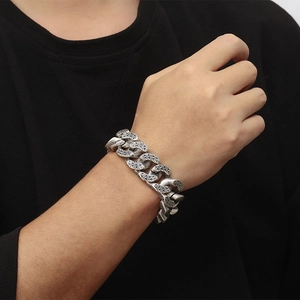 Detail of silver dragon scale pattern on a heavy stainless steel chain bracelet for men