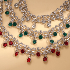 Close-up of vintage teardrop necklaces with rhinestones in white, green, and red jewel tones