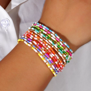 Colorful multi-layer seed bead bracelet set with gold accents for a summer bohemian style