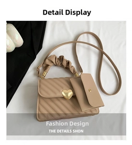 Macro detail of beige quilted handbag with heart lock, ruffled handle and coin purse