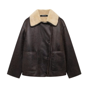 Close-up of deep brown shearling jacket with large pockets and cream faux fur collar