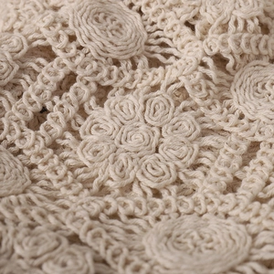 Close-up of intricate beige floral lace pattern on handmade summer crochet beanie hat