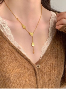 Detail of 18k gold plated hulu gourd pendant necklace worn on a female model's neck