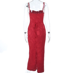 Close-up of red jacquard fabric dress showing back lace-up detail and hem slit