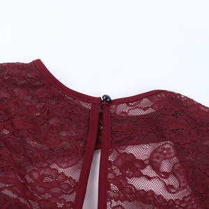 Detailed close-up of the back neck button closure on a burgundy lace long sleeve top