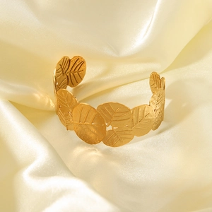 Bohemian gold plated leaf open cuff bracelet in stainless steel on white silk