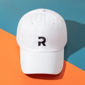 White cotton baseball cap with black letter R embroidery on vibrant two-tone background