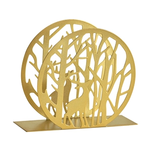 Golden iron napkin holder with life tree and reindeer silhouette in modern minimalist style