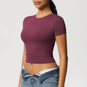 Close-up of slim fit berry purple cropped yoga top with short sleeves and high-stretch fabric