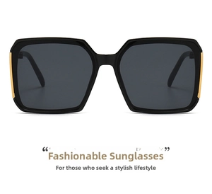Detail of square black sunglasses featuring gold metal accents on the hinges