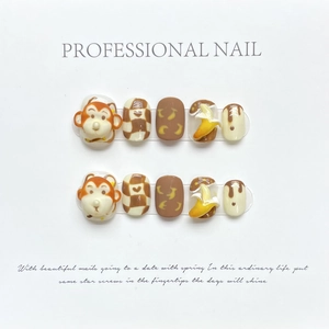3D handmade press-on nails featuring cute monkey and banana designs with checkered patterns