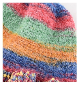 Macro shot of colorful oil painting knit bucket hat featuring soft rainbow mohair texture