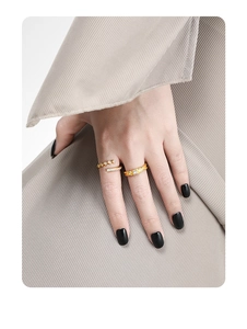Close-up of stacked gold-plated S925 silver rings with zircon stones on model's hand