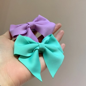 Pastel lavender and mint green bow hair clips in textured fabric for women and girls