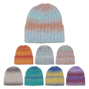 Detailed view of tie-dye gradient knit beanies showing ribbed texture and various colors